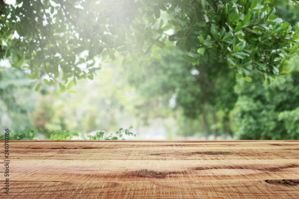 Wooden table and blurred green nature garden background. Wooden table and blurred green nature garden background.