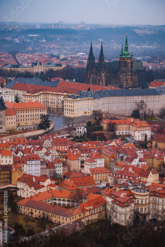 View on the red roofs of Mala Strana and St. Vitus Cathedral in Prague. Overcast weather