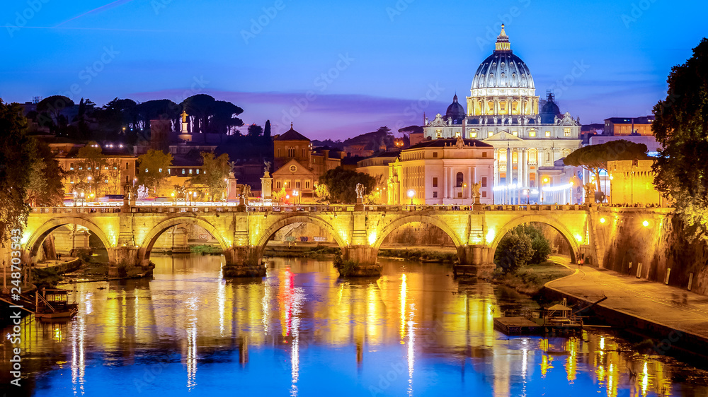 The dome of Saint Peters Basilica and Vatican City at dusk. Sant'Angelo Bridge over the Tiber River. Rome, Italy