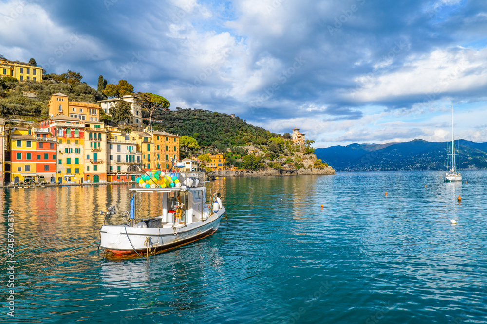 Boat on the water close up with and view of the spectacular bay of Portofino in Liguria, Italy