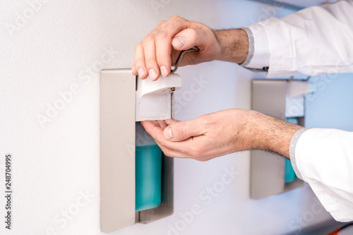 The doctor disinfects his hands