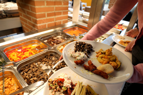 self service restaurant with many raw and cooked foods photo