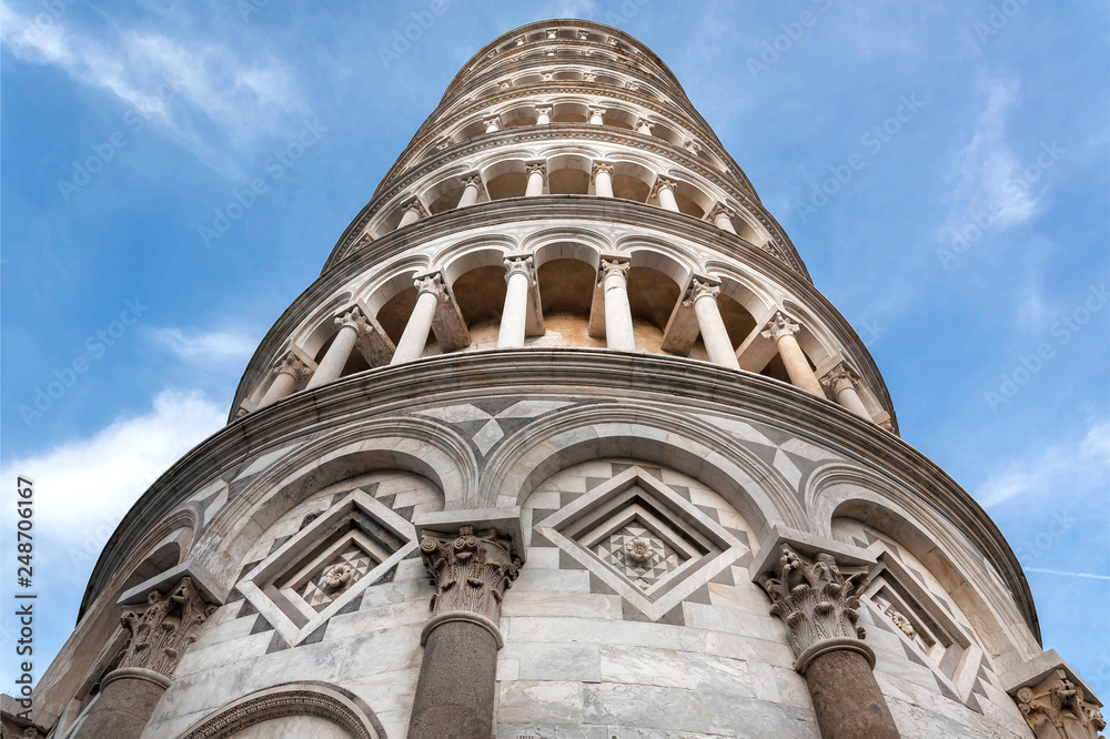 Blue sky over 14th century Leaning Tower of Pisa, Italy. UNESCO World Heritage Site