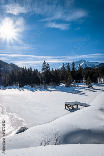 Snow covered frozen lake in holiday-resort Hohentauern on winter day