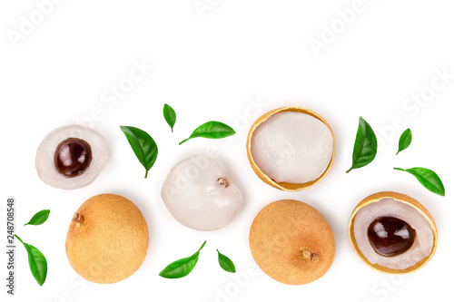 Fresh longan fruit with leaves isolated on white background. Top view. Flat lay photo