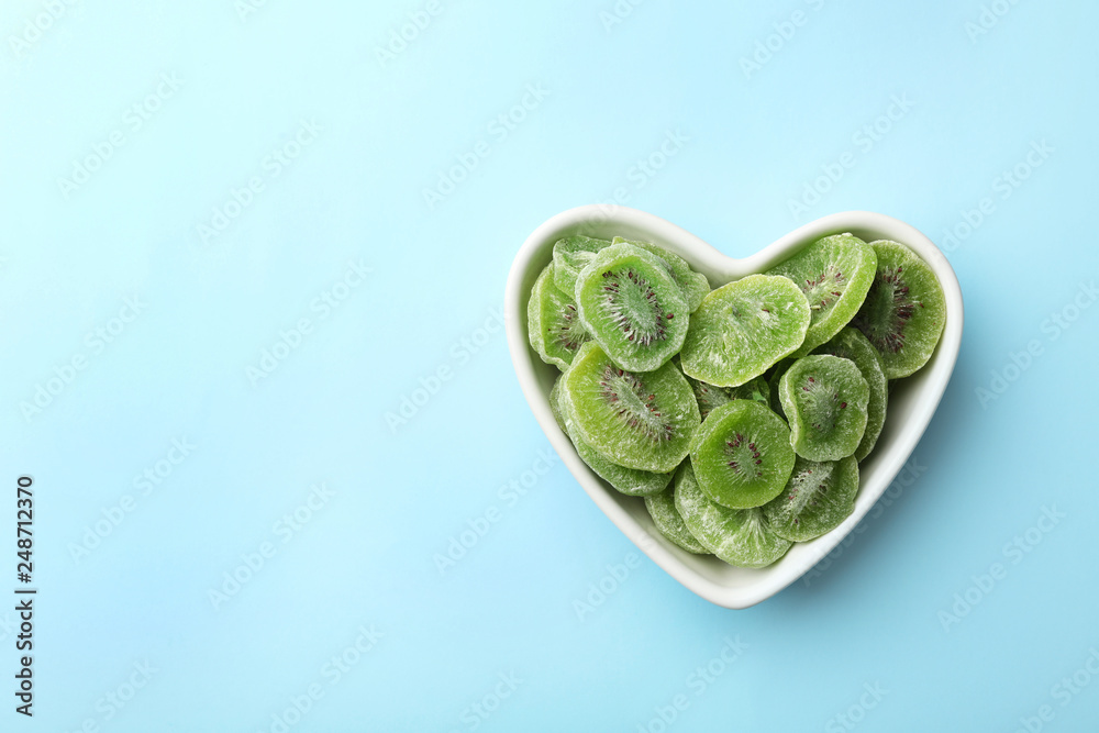 Bowl of dried kiwi on color background, top view with space for text. Tasty and healthy fruit Bowl of dried kiwi on color background, top view with space for text. Tasty and healthy fruit