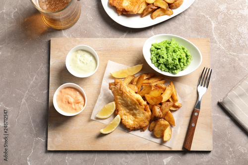 British traditional fish, potato chips and mushy peas on color background, top view