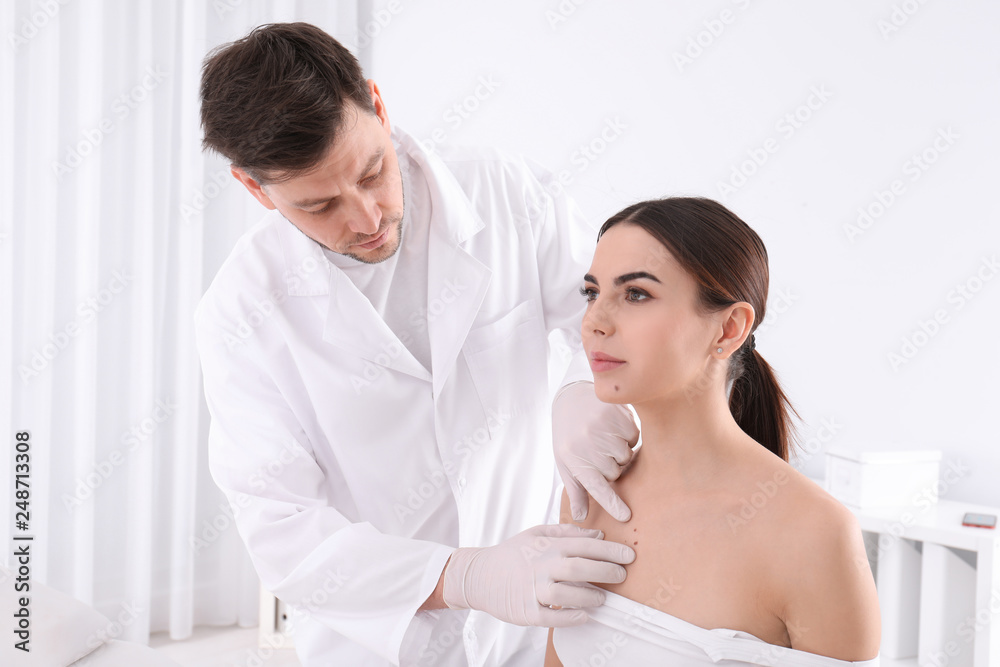 Doctor examining patient in clinic. Visiting dermatologist Doctor examining patient in clinic. Visiting dermatologist