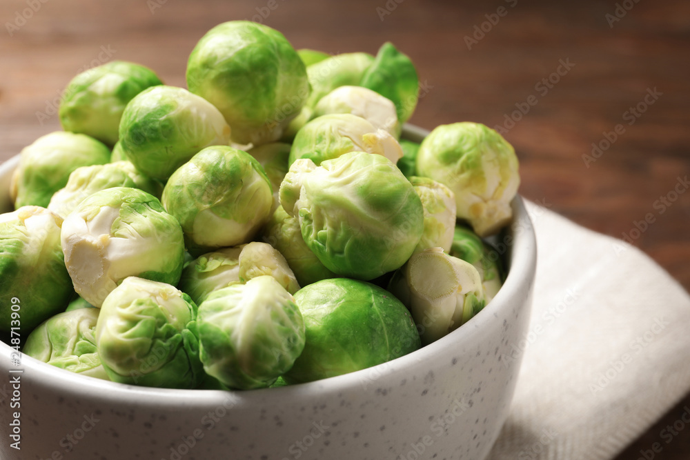Bowl of fresh Brussels sprouts on table, closeup. Space for text Bowl of fresh Brussels sprouts on table, closeup. Space for text