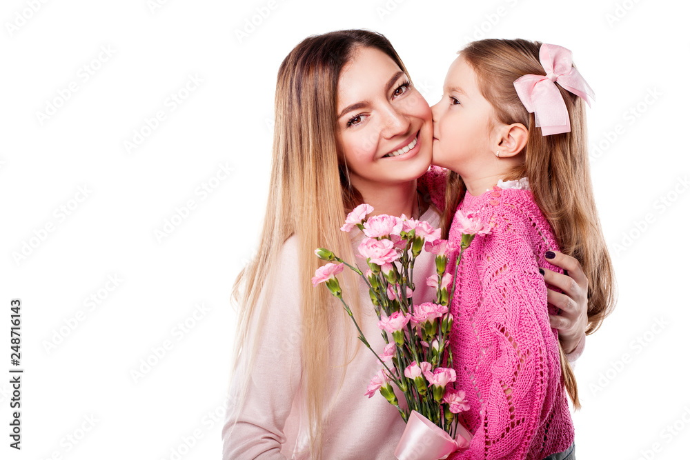 Portrait of happy smiling mother and daughter with bouquet of pink carnations isolated on white. Daughter kisses her mother. Happy family. Happy mother's day. Mothers day card.