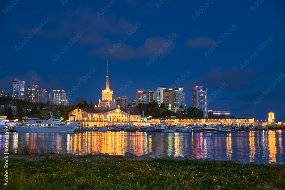 Obraz premium Yachts and boats anchored in the port of Sochi at sunset. Russia.
