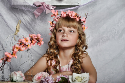 Blond girl with white flowers in her hair. photo