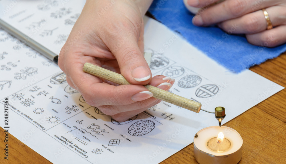 Naklejka premium Beeswax or paraffin should be placed in a special device, heated over a candle-tablet. The wax will melt and you can draw. Easter is the oldest and most important Christian holiday