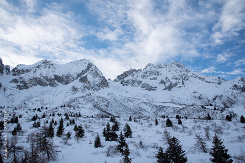 View of the mountains around the Tonale Pass during a winter sunny day. Tonale is a mountain pass between Lombardy and Trentino, near the Adamello park and the Presena glacier, in the north of Italy