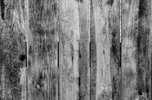 Weathered wooden fence in black and white.