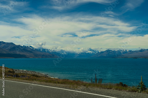 Lake Pukaki view from Glentanner Park Centre near Mount Cook, on a background of blue sky with clouds, snowy Southern Alps © FitchGallery