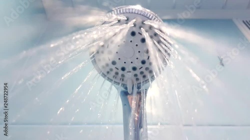 The shower turns on, the water flows to the camera.
