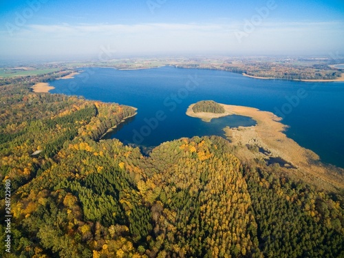 Aerial view of beautiful landscape of Mazury region during autumn season, Mamry Lake in the background, Poland