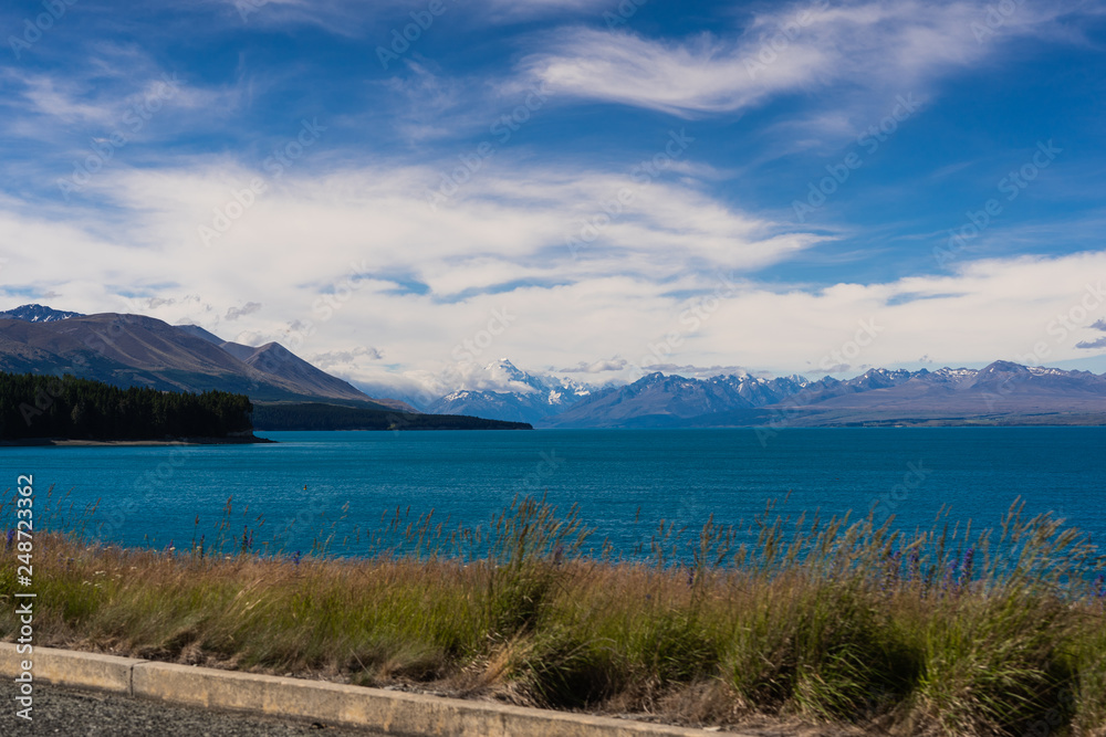 Obraz premium Lake Pukaki view from Glentanner Park Centre near Mount Cook, on a background of blue sky with clouds, snowy Southern Alps
