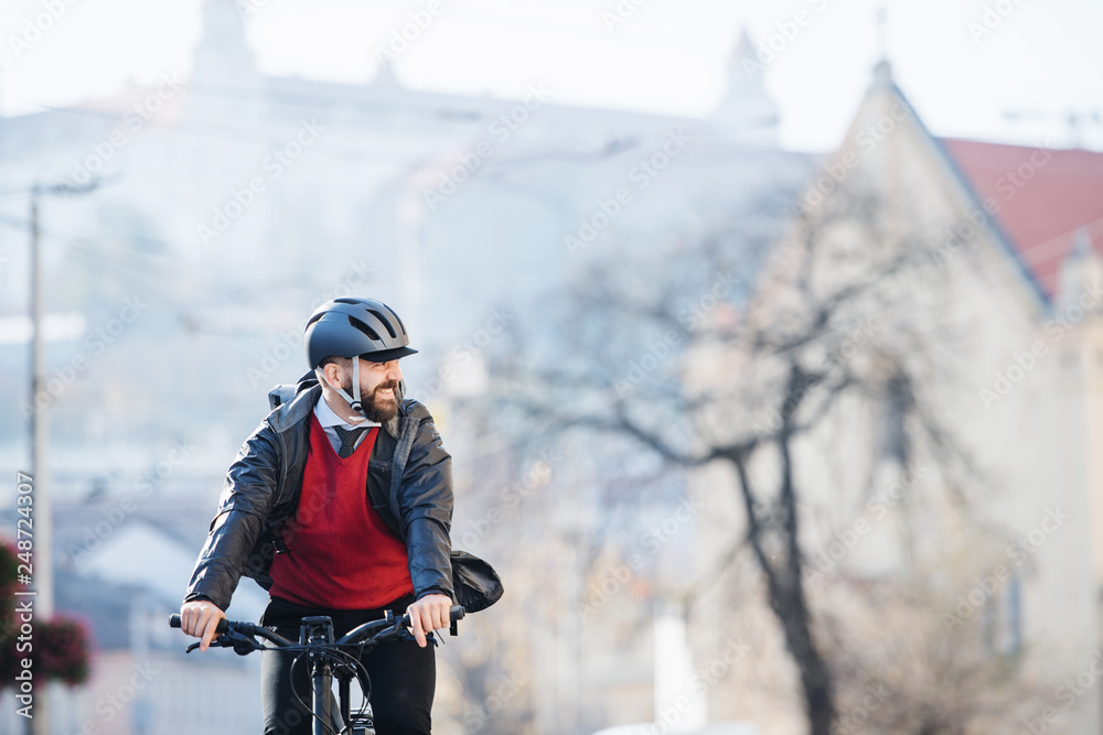 Hipster businessman commuter with bicycle traveling to work in city.