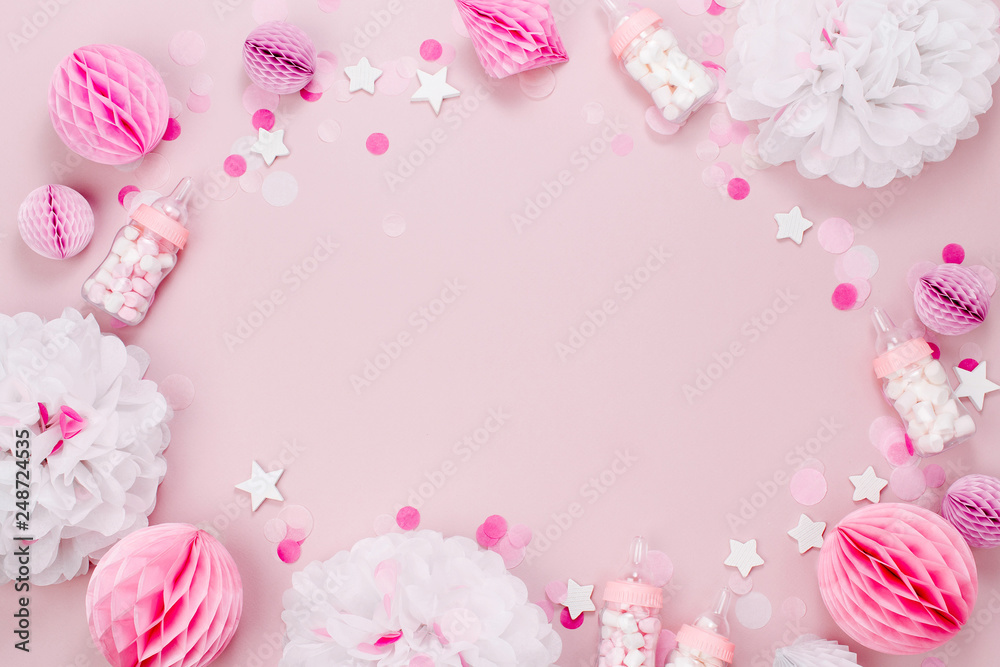 Frame made of Decorative Baby milk bottles with candy and paper decorations for Baby shower party. Flat lay, top view Frame made of Decorative Baby milk bottles with candy and paper decorations for Baby shower party. Flat lay, top view