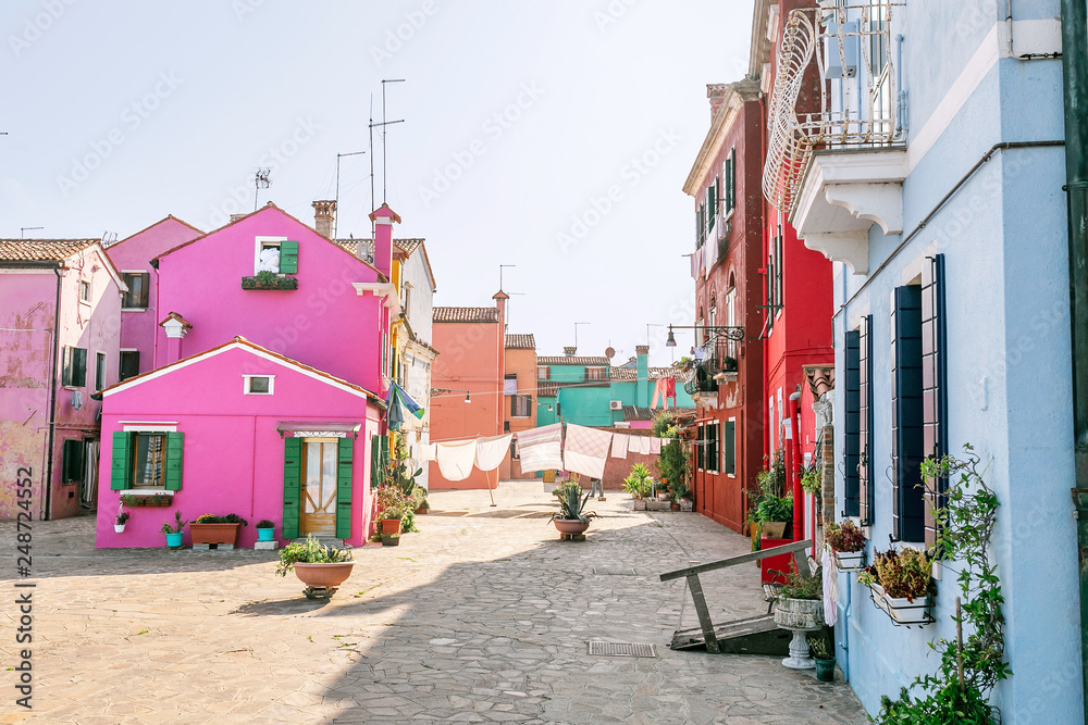 Colorful houses on the street in Burano island, near Venice. Tourism and vacation in Italy concept