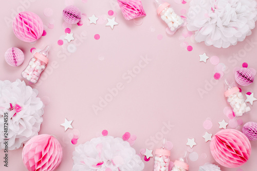 Frame made of Decorative Baby milk bottles with candy and paper decorations for Baby shower party. Flat lay, top view