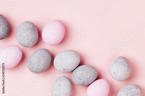 Stylish background of pale pink and gray Easter eggs. Dyed Easter eggs. Flat lay