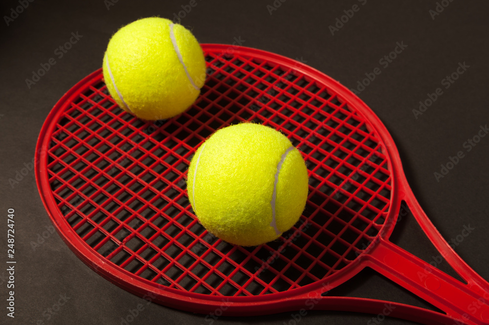 two tennis ball and red racket
