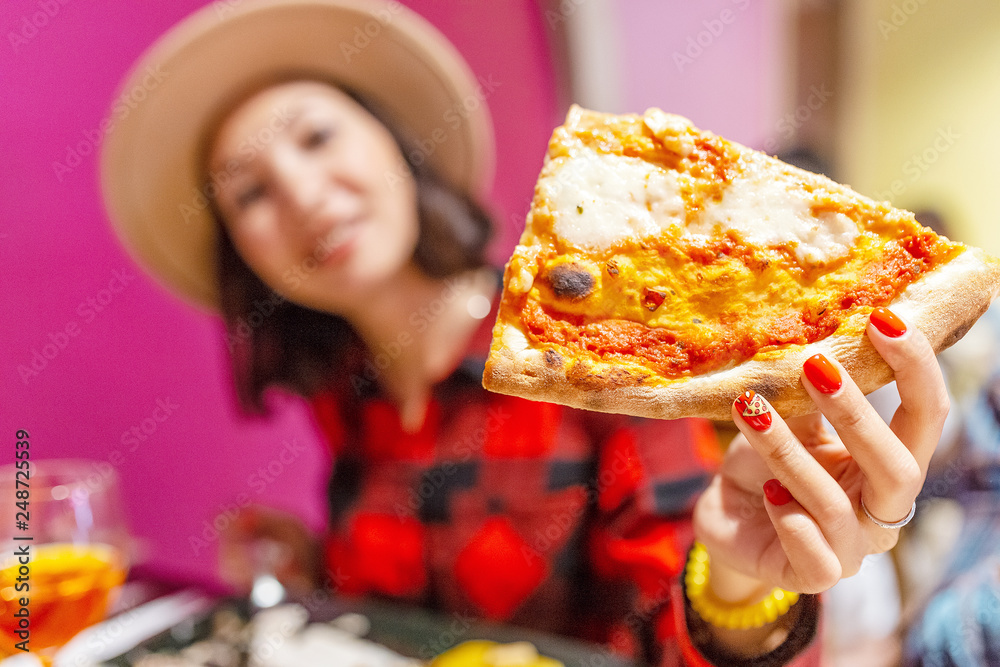 Funny brunette asian girl eating pizza at restaurant Funny brunette asian girl eating pizza at restaurant