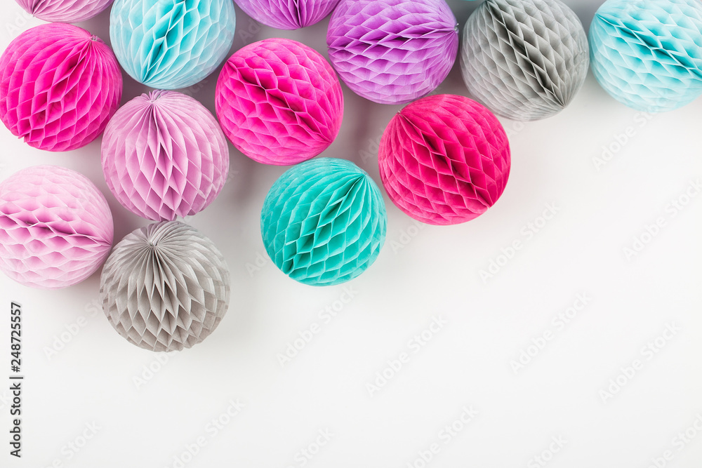 Honeycomb balls decorations background. Pink, lilac and turquoise paper pom pom. Flat lay. Holiday concept Honeycomb balls decorations background. Pink, lilac and turquoise paper pom pom. Flat lay. Holiday concept