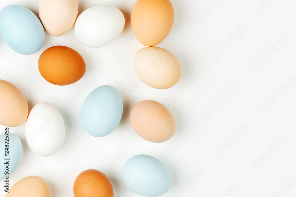 Natural Colored brown and white Eggs on light background. Compositions in pastel colors. Easter consept. Flat lay, top view Natural Colored brown and white Eggs on light background. Compositions in pastel colors. Easter consept. Flat lay, top view