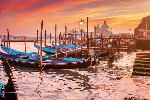 Majestic Gondolas in Venice at the sunset. Panoramic view of the San Giorgio Maggiore church from San Marco square. Travel and Vacation in Italy concept © EdNurg