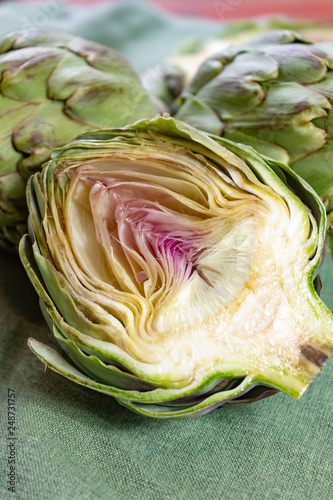 Heads of fresh uncooked artichoke flowers close up