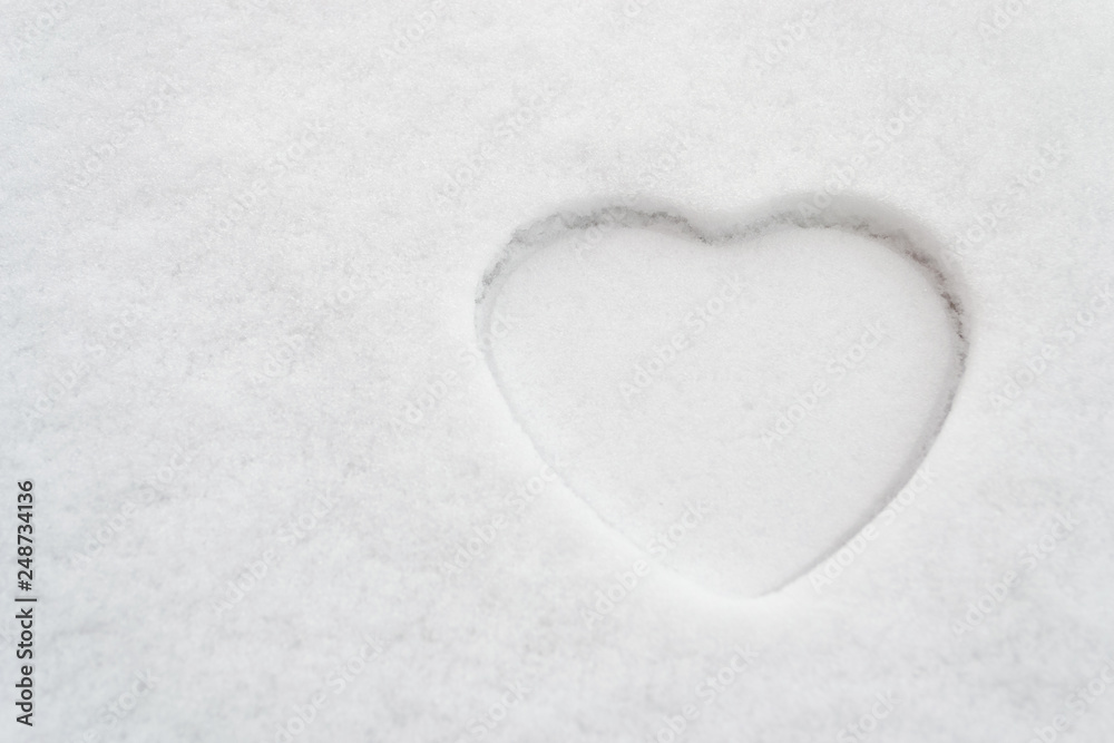 One big white heart shape in snow. 14 February concept, Mother's Day or Women's Day theme.