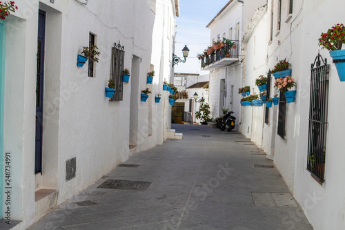 Mijas, Spain, 24th January 2019. A side street in white village of Mijas brightly decorated with flower pots