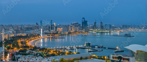 Beautiful business night view of Baku downtown, wide panoramic photograph