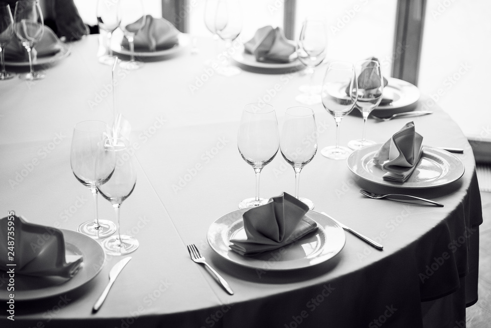 Tables set for an event party or wedding reception. Glasses and dishes. Tables set for an event party or wedding reception. Glasses and dishes.