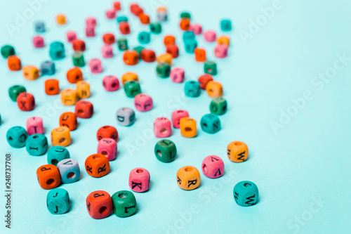 Colored cubes with letters on a blue background.