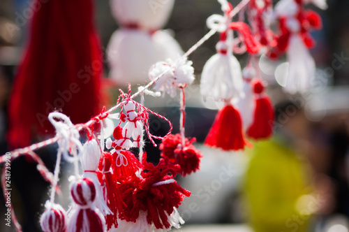 Traditional martisoare and martenitsa closeup in sunny weather with blurred background outdoors, Concept of spring celebration photo