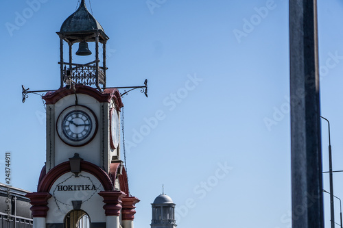 clocktower in hotikita New Zealand, clock tower in the city centre of hotikita, clock tower with natural blue sky in the background photo