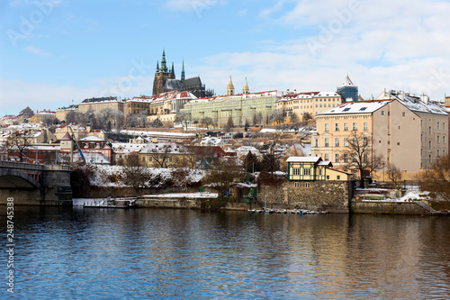 Snowy Prague Lesser Town with Prague Castle above River Vltava in the sunny Day, Czech republic