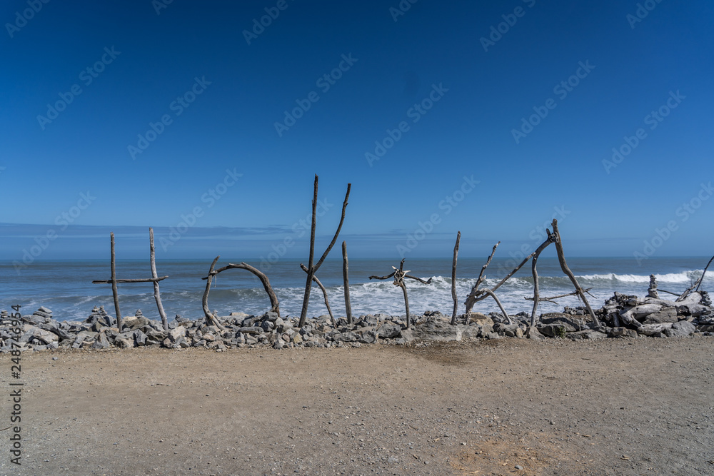 Hotikita Sign on the beach of hotikita New Zealand, wood in the sand of the beach of the beautiful jade city hotikita of New Zealand Hotikita Sign on the beach of hotikita New Zealand, wood in the sand of the beach of the beautiful jade city hotikita of New Zealand
