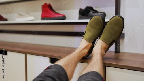 POV, this is not place for your legs, foot with boots on a table in shop photo