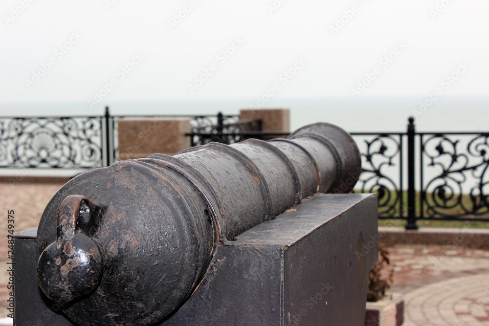 Old cannon installed on the city embankment as a monument Old cannon installed on the city embankment as a monument