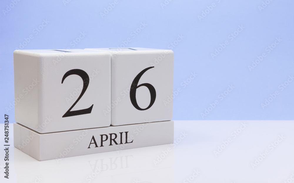 April 26st. Day 26 of month, daily calendar on white table with reflection, with light blue background. Spring time, empty space for text April 26st. Day 26 of month, daily calendar on white table with reflection, with light blue background. Spring time, empty space for text