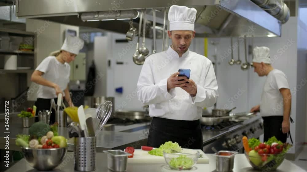 chef preparing salad then good news on smartphone chef preparing salad then good news on smartphone