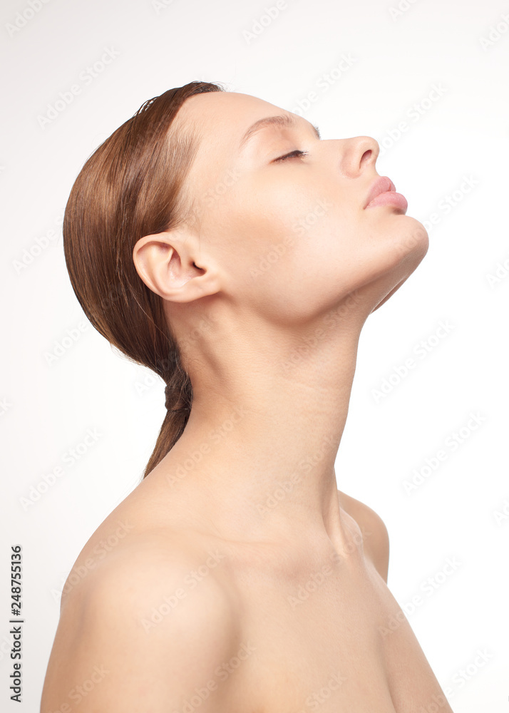 Beauty portrait of young girl with brown hair and big lips on white background with clean face skin and arm near head. Good for cosmetic, medicine and spa . European type Beauty portrait of young girl with brown hair and big lips on white background with clean face skin and arm near head. Good for cosmetic, medicine and spa . European type