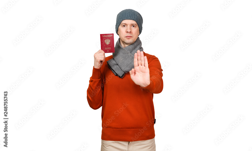 The Caucasian man with the international passport of the Russian Federation in warm clothes. Holds the opened palm before itself, the gesture - an appeal will stop