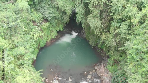 Aerial view above a beautiful lagoon in the mountains of South East Asia, Natural pool below a waterfall, secret places in the world that is untouched photo